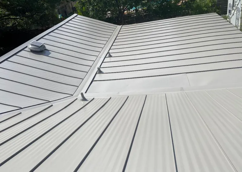 Solar attic fan installed on a metal roof for Roof Ventilation in Saugus
